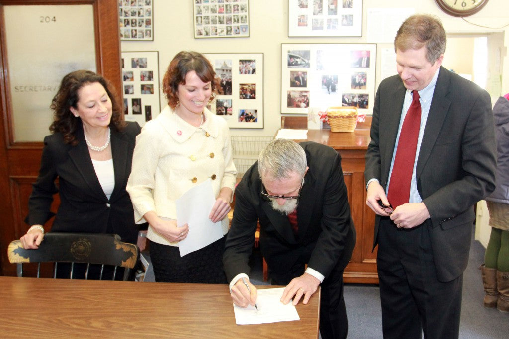 L-R: NH Senator Molly Kelly, Rebecca Hamilton, Bill Whyte, and Deputy Secretary of State David Scanlon. Bill and Rebecca are registering Badger as one of New Hampshire's first benefit corporations.